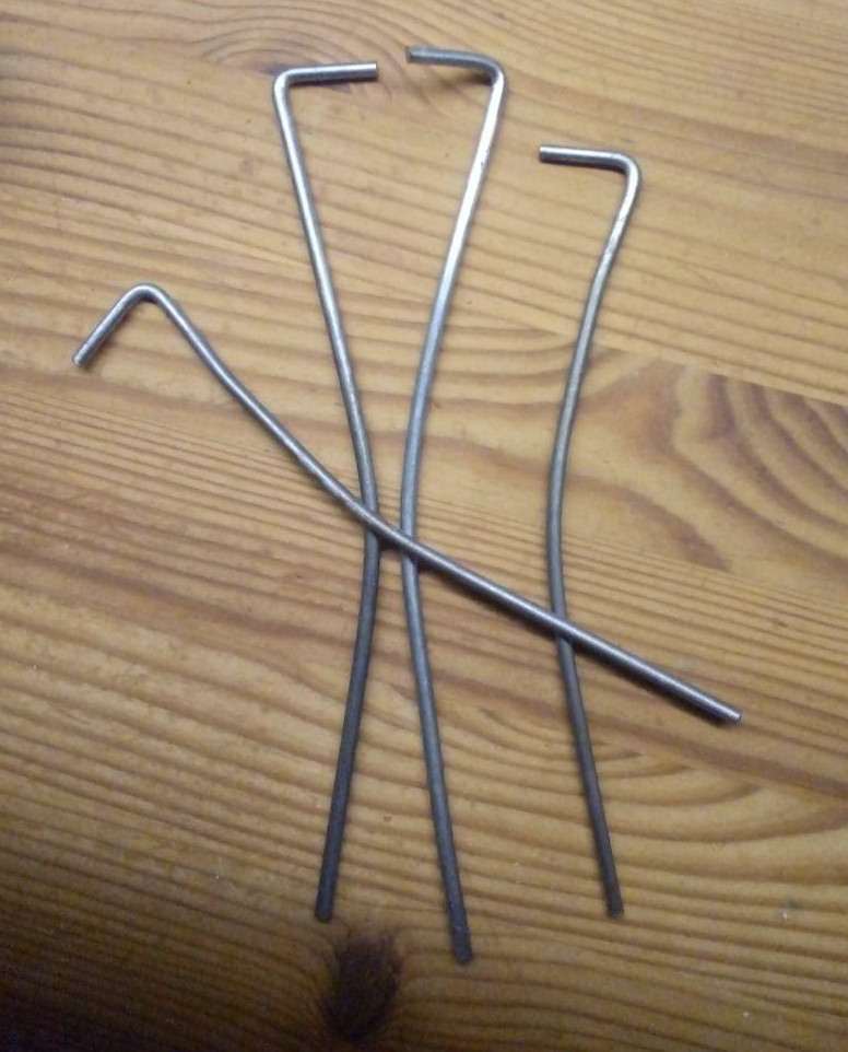Bent tent pegs after a failed attempt with simple steel pegs